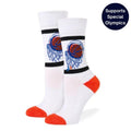 A pair of white crew socks with a basketball hoop and ball graphic on the upper leg, featuring black stripes, a blue heel, and orange toes and heels. A dark blue circular badge in the top right corner reads 'Supports Special Olympics'.