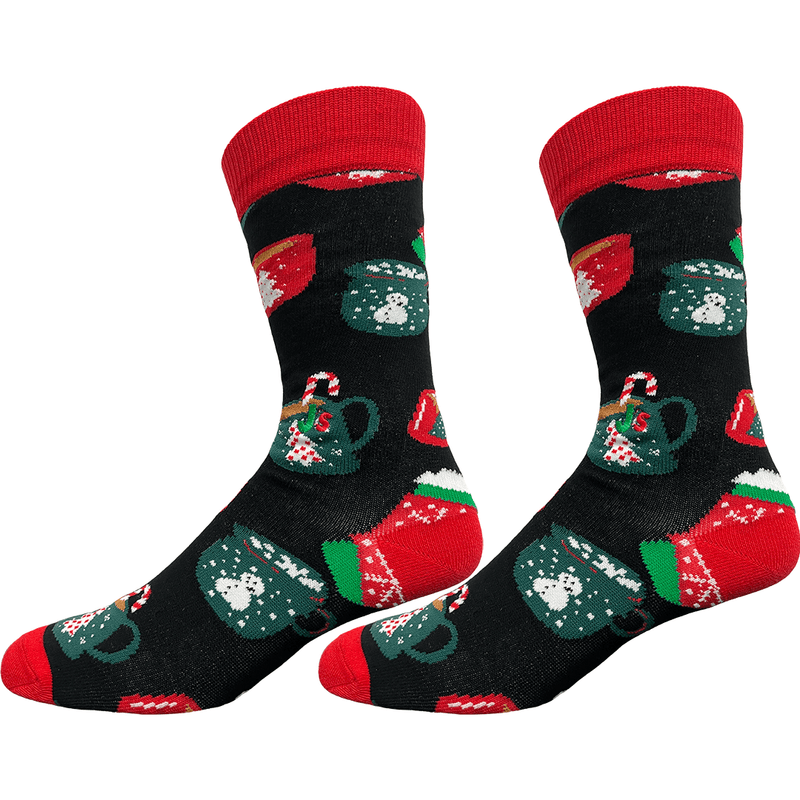 A pair of crew socks with a black background and a festive Christmas pattern featuring red, green, and white holiday motifs, including candy canes, snow-covered mugs, and red heels and toes.