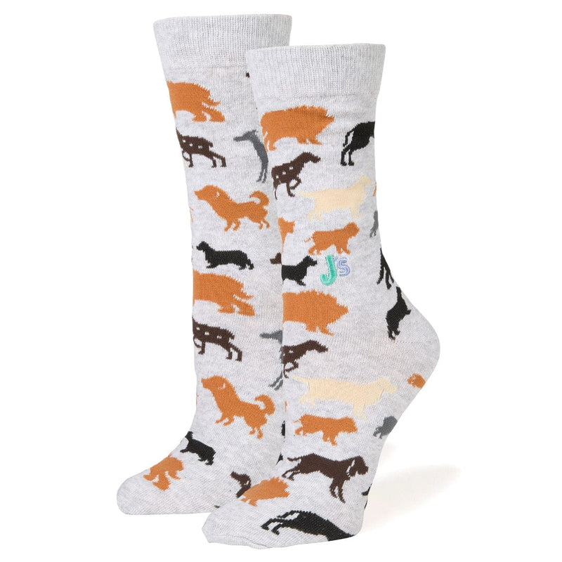 A pair of light gray crew socks with an all-over pattern of various dog silhouettes in orange, black, brown, and cream, displayed against a plain white background.