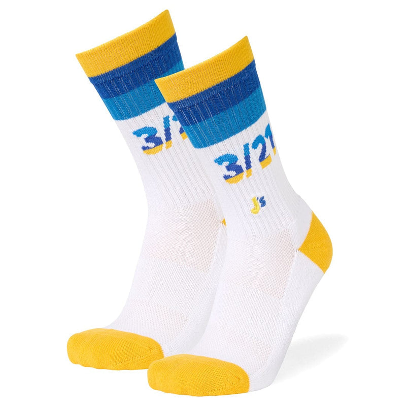 A pair of white crew socks with yellow and blue accents, featuring the text '3/21' in blue and yellow on the side, set against a plain white background.
