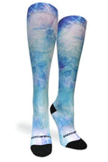 A pair of knee-high compression socks with a blue and white galaxy nebula print, featuring black toes and heels, and the brand name 'COREY COMPRESSION' printed in white near the sole.